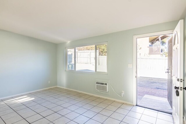 interior space featuring a wall unit AC and light tile patterned floors