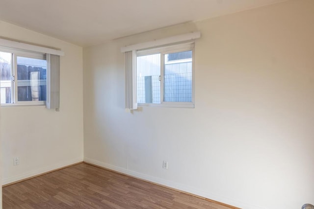 unfurnished room featuring hardwood / wood-style flooring