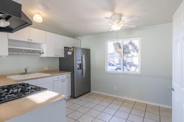 kitchen with white cabinets, range hood, stainless steel fridge, and sink