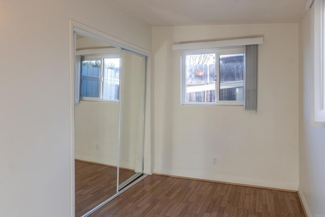 unfurnished bedroom featuring a closet and hardwood / wood-style floors