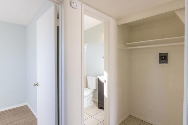 laundry area with light tile patterned flooring