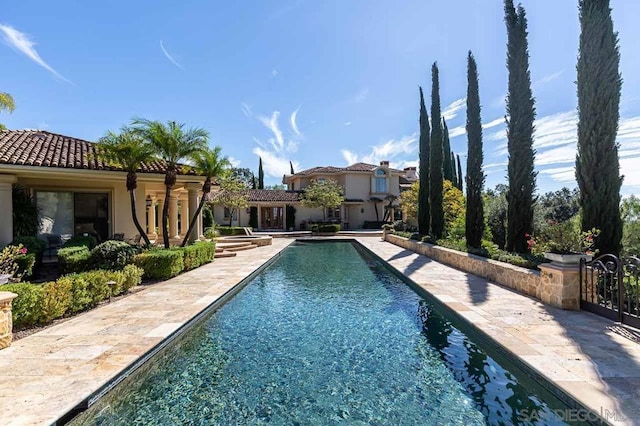 view of swimming pool with a patio area