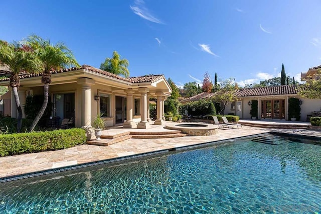 view of swimming pool with a patio area and an in ground hot tub