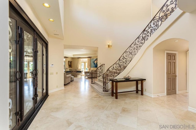 entrance foyer featuring a high ceiling and french doors