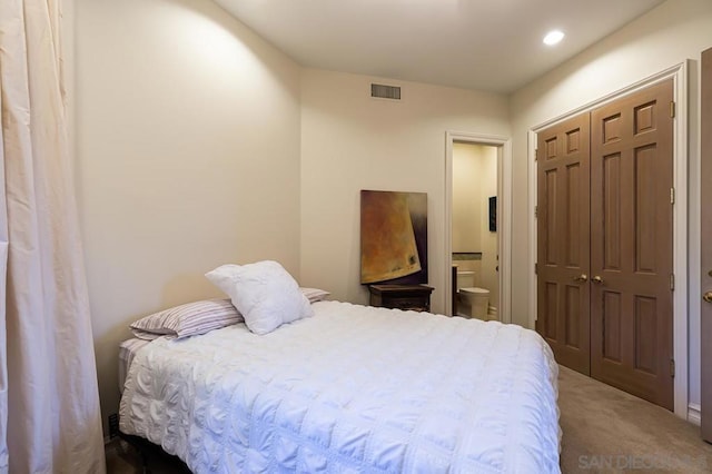 bedroom with carpet flooring, a closet, and connected bathroom