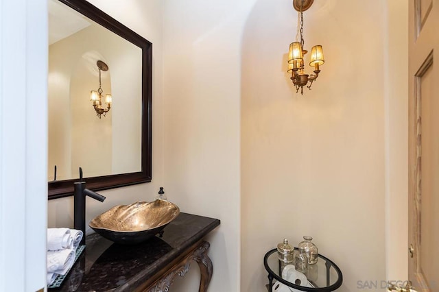 bathroom with sink and an inviting chandelier