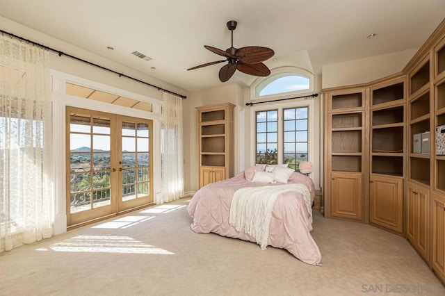 bedroom with ceiling fan, light colored carpet, french doors, and access to outside