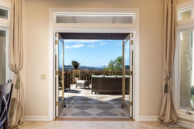 doorway featuring light tile patterned floors and a mountain view