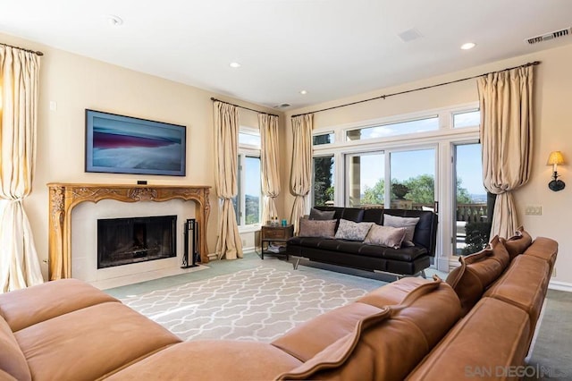 living room featuring a fireplace and carpet flooring