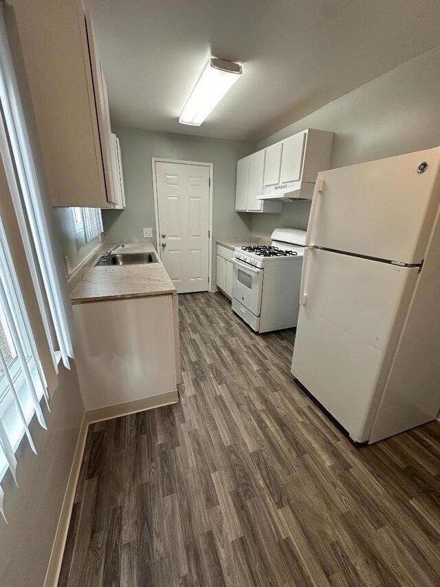 kitchen with white appliances, dark wood-type flooring, sink, and white cabinetry