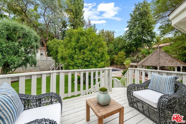 wooden terrace featuring outdoor lounge area