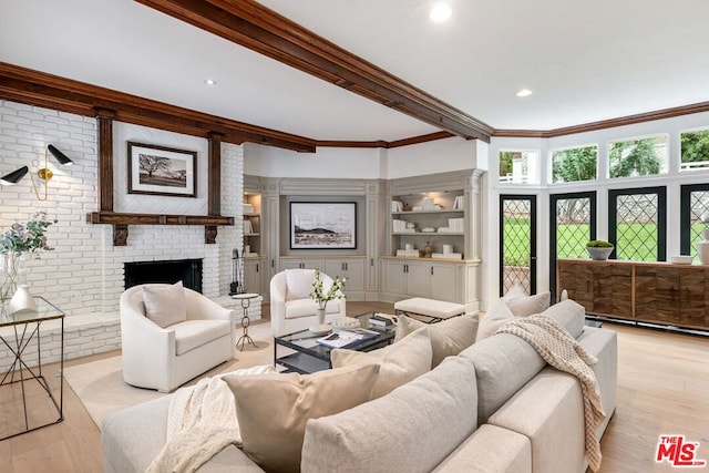 living room featuring a fireplace, ornamental molding, and light hardwood / wood-style flooring