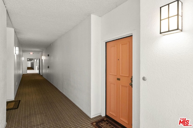 hallway with a textured ceiling