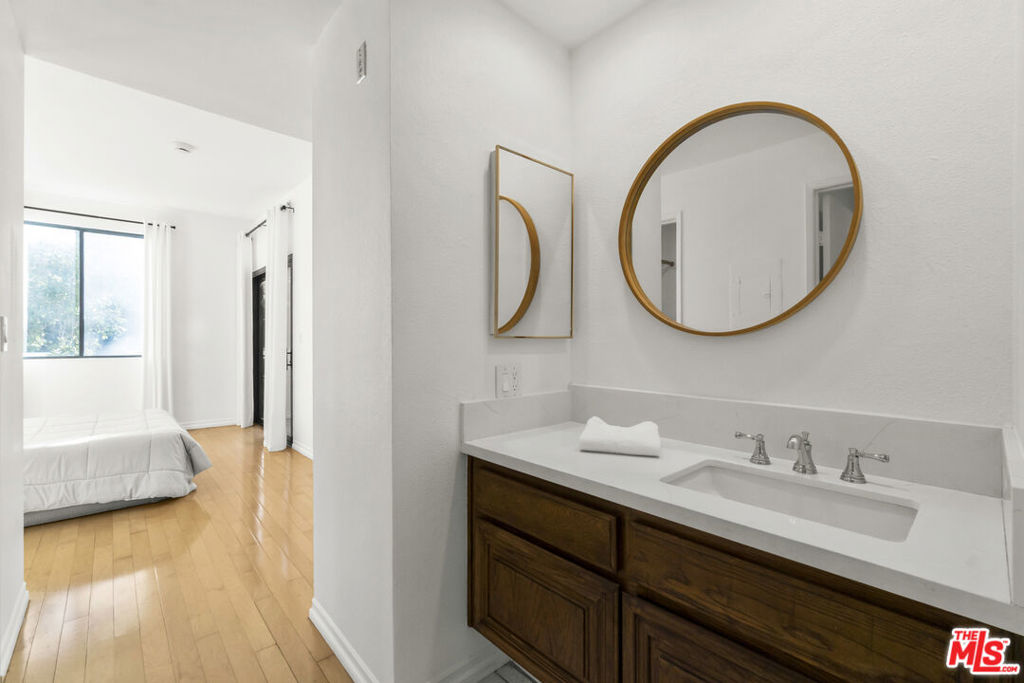 bathroom with vanity and wood-type flooring