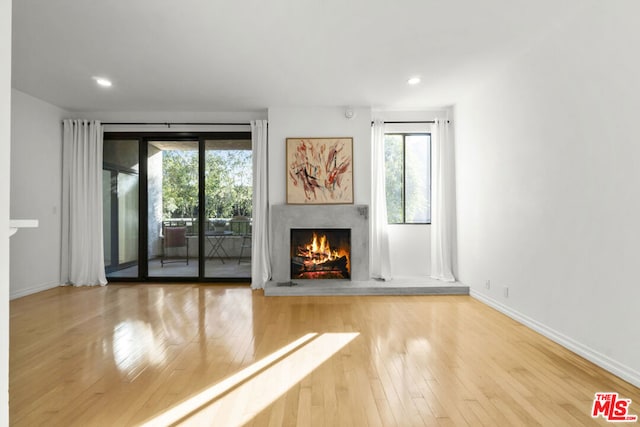 unfurnished living room with a fireplace and hardwood / wood-style flooring