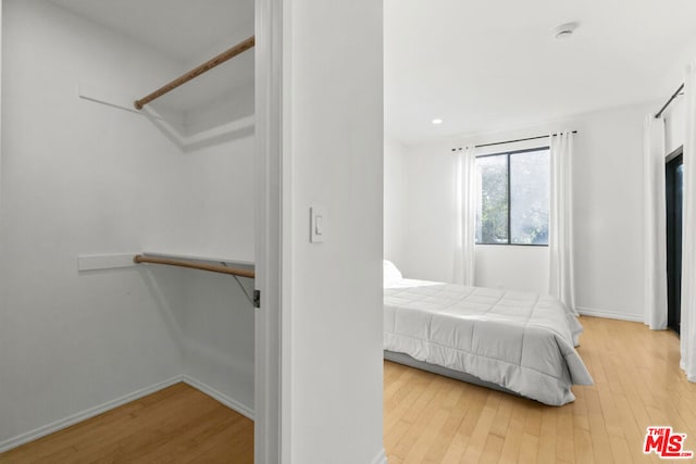 unfurnished bedroom with light wood-type flooring