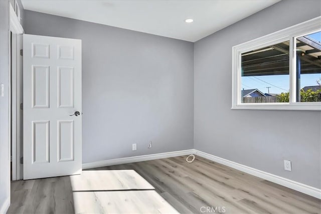 spare room with light hardwood / wood-style flooring