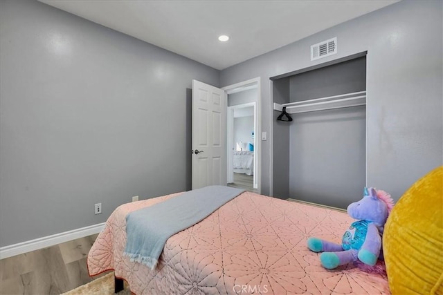 bedroom featuring hardwood / wood-style flooring and a closet