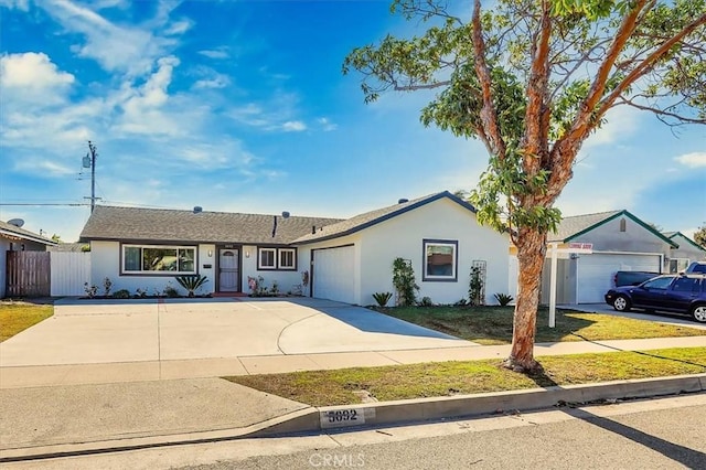 ranch-style home featuring a front lawn and a garage