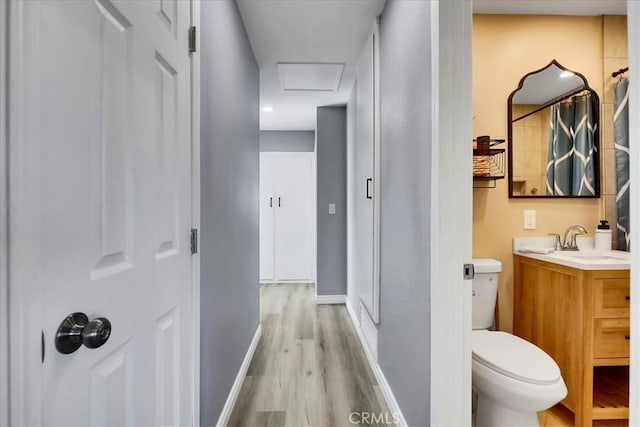 bathroom featuring toilet, vanity, and hardwood / wood-style floors