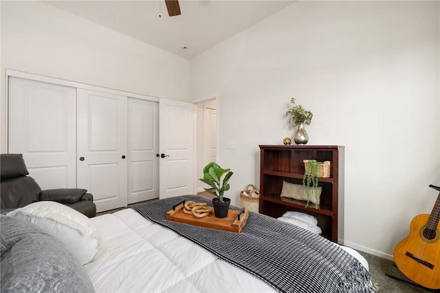 carpeted bedroom featuring ceiling fan and a closet