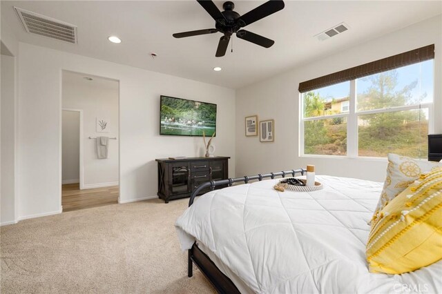 bedroom featuring ceiling fan and light colored carpet