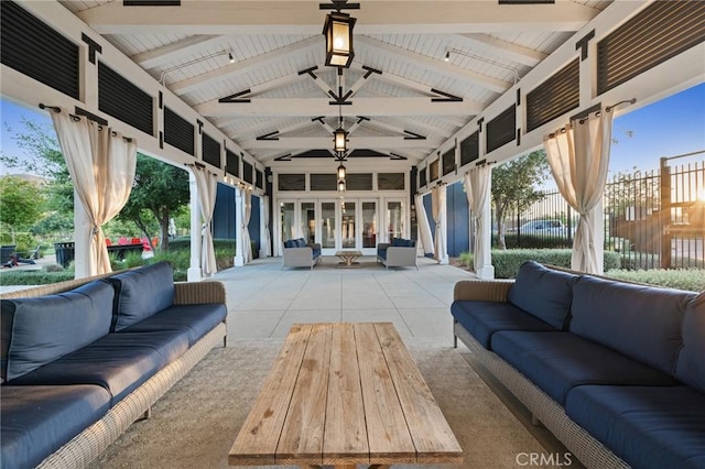 sunroom / solarium featuring lofted ceiling with beams