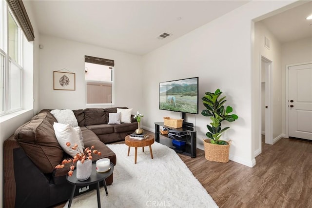 living room featuring dark hardwood / wood-style flooring and plenty of natural light