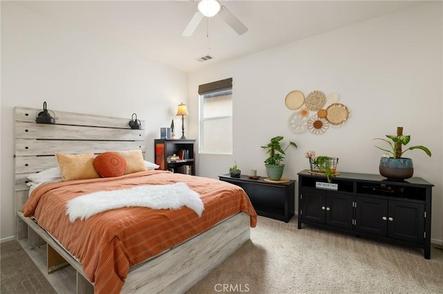 bedroom with ceiling fan and light carpet