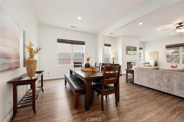 dining space featuring ceiling fan and dark hardwood / wood-style floors