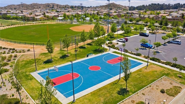 view of basketball court with a yard and a mountain view