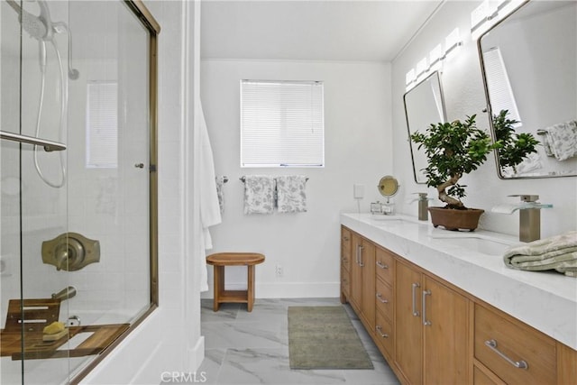 bathroom with shower / bath combination with glass door and vanity