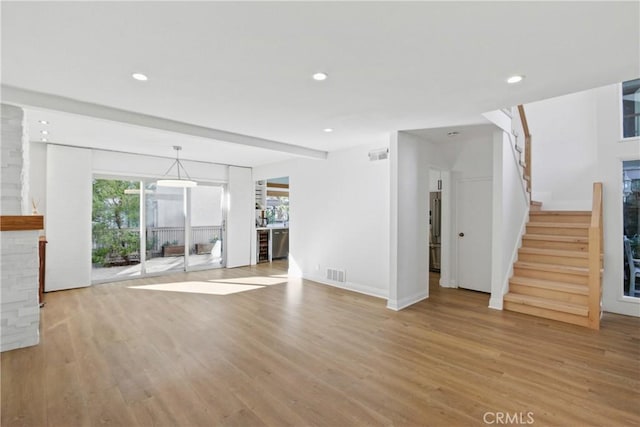 unfurnished living room with light hardwood / wood-style flooring