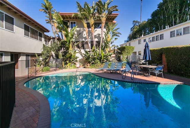 pool featuring a patio and fence