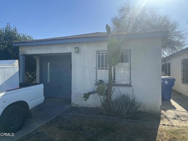 exterior space with stacked washer / drying machine and a garage