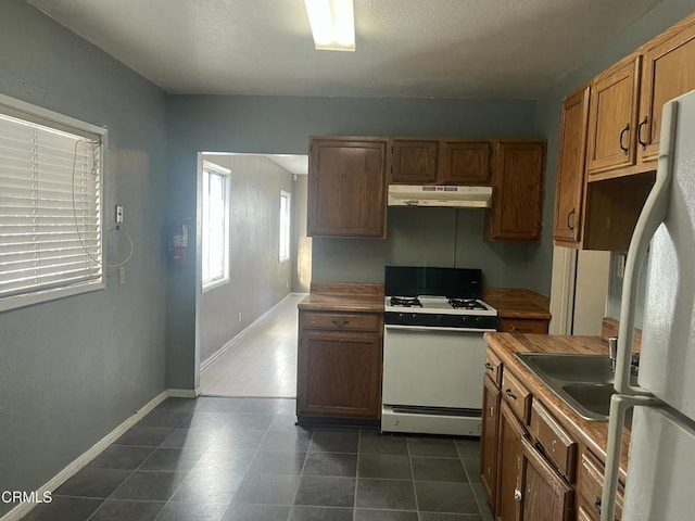 kitchen featuring white appliances and sink