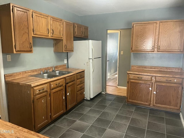 kitchen with sink and white fridge