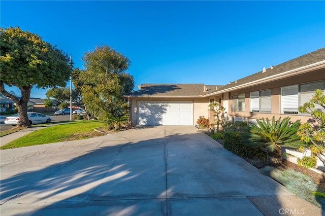 view of front of house with a front yard and a garage