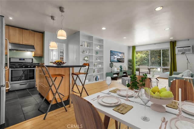 tiled dining space featuring a wall mounted air conditioner