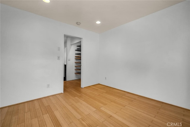 empty room with light hardwood / wood-style flooring