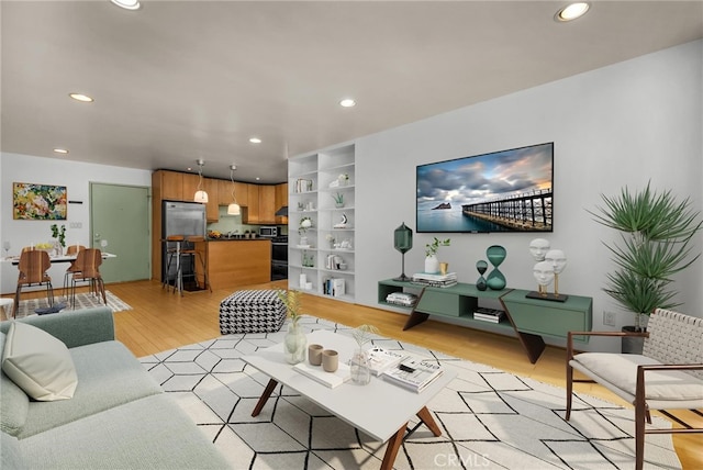 living room featuring light hardwood / wood-style floors and built in shelves