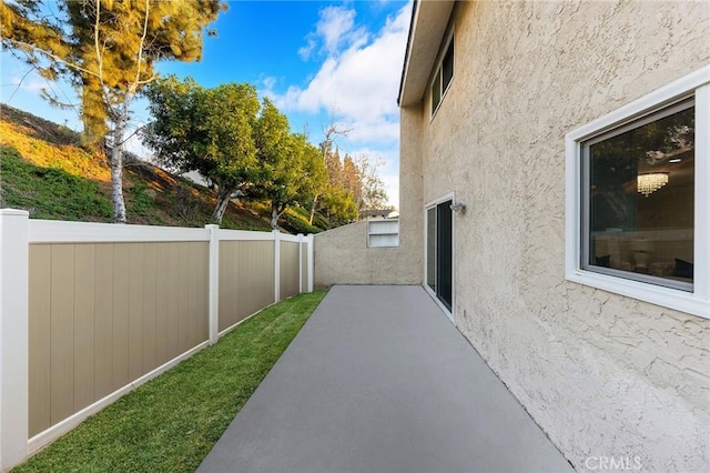 view of side of property with a patio area