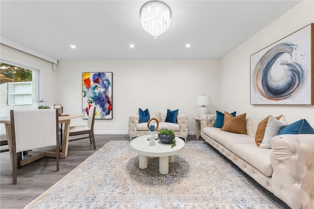 living room featuring a chandelier and wood-type flooring