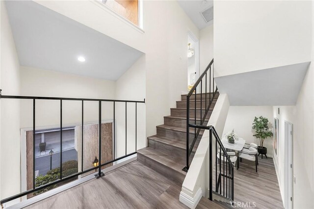 stairway with hardwood / wood-style floors