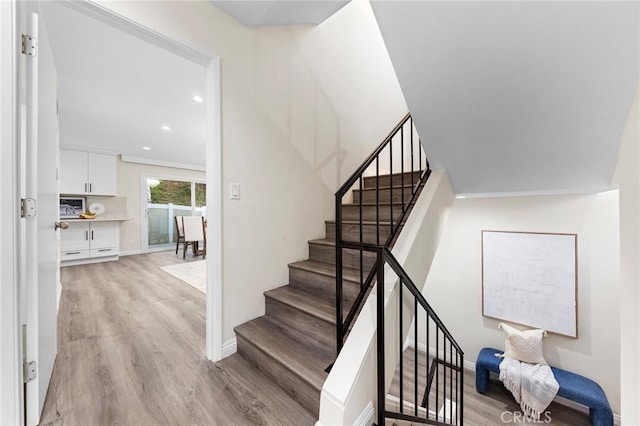 stairs featuring wood-type flooring