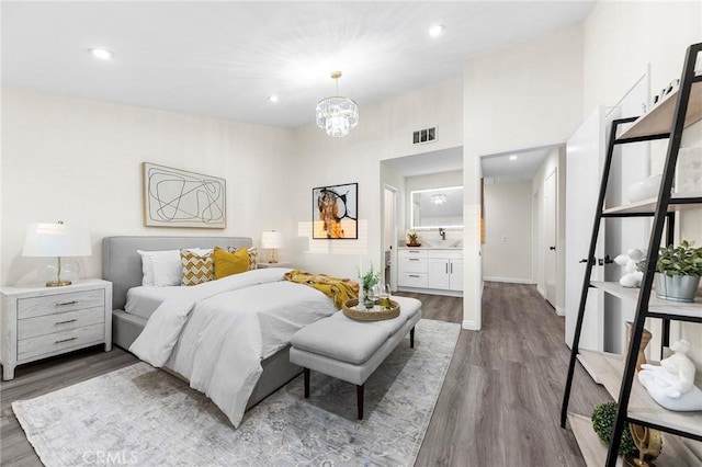 bedroom featuring wood-type flooring and a chandelier