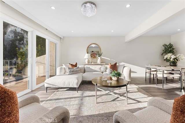 living room with beam ceiling and wood-type flooring