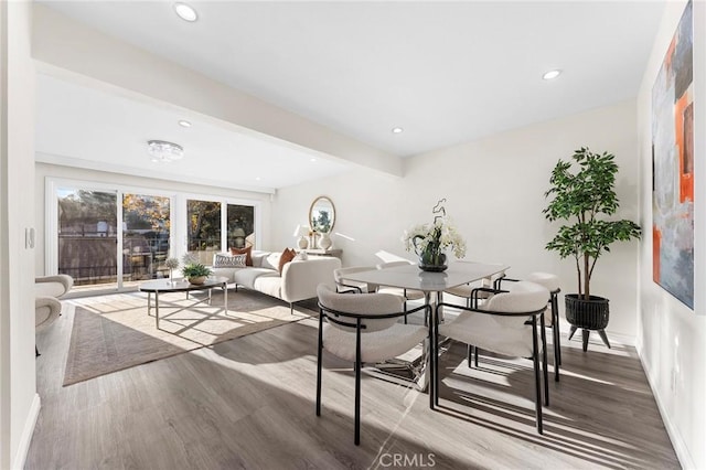 dining room featuring beam ceiling and hardwood / wood-style flooring