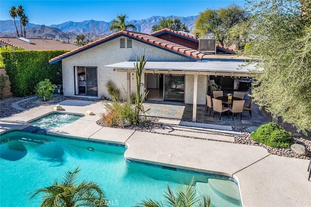 rear view of property with a patio area and a mountain view