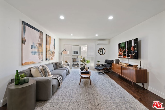 living room featuring a wall mounted air conditioner and dark hardwood / wood-style floors